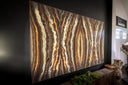 3d printed abstract art wall panel with swirling patterns in shades of brown, beige and gold.