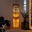 Illuminated 63-inch Aqua Onyx floor lamp glowing with cream, aqua, honey, and caramel natural stone banding