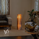 Illuminated Aqua Onyx floor lamp glowing with cream, amber, caramel, brown, and subtle aqua vertical banding