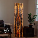 Illuminated Tangerine Onyx floor lamp glowing with tangerine, amber, cream, and dark vertical mineral banding