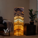 Aqua Onyx tower lamp lit from within to reveal dramatic layered natural stone banding and glowing translucency