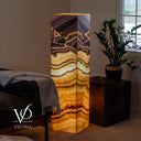 Illuminated Aqua Onyx floor lamp glowing with cream, honey, amber, brown, and subtle aqua-green mineral layers