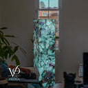 Handcrafted Fluorite tower lamp illuminated to reveal translucent green stone and deep purple mineral inclusions