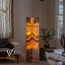 Illuminated 59-inch Miami Sunset Onyx floor lamp glowing with amber, orange, cream, burgundy, and brown natural banding
