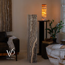 Unlit rectangular Tangerine Onyx tower showing cream, gray, amber, and espresso natural stone formations