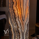 Glowing Tangerine Onyx floor lamp with layered orange, cream, charcoal, and espresso mineral movement