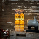 Decorative lamp with layered design on a wooden surface, with 'Vilona' branding.