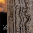 Tangerine Onyx floor lamp photographed unlit to reveal polished stone texture and organic mineral banding