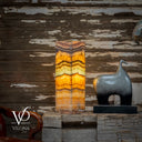 Decorative lamp with layered design on a wooden surface, featuring the VILONA