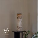 Unlit Sahara Onyx cylinder table lamp showing natural ivory, cream, taupe, caramel, and brown coloring