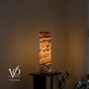 Natural Sahara Onyx table lamp glowing with horizontal cream, honey, taupe, and brown banding