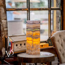 Decorative lamp with marble-like pattern on a wooden table in a cozy room.