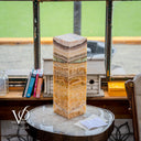 Decorative stone column on a round table with a blurred indoor background