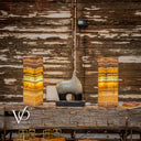 Decorative two striped lamps against a rustic wooden wall with 'Vilona' branding.