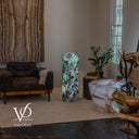 Angled view of fluorite floor lamp #5 illuminated to show the different patterns on two stone faces
