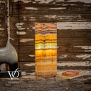 Decorative lamp with multicolored layers on a rustic wooden surface, featuring the brand 'Vilona'.