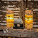 Decorative lamps with a unique design on a rustic wooden surface, featuring the brand 'Vilona'.
