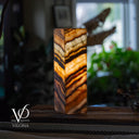 onyx lamp with layered pattern on a blurred background, featuring the Vilona logo.