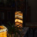 Decorative lamp with a wavy pattern on a wooden surface, blurred background