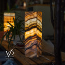 Marble-patterned lamp on a wooden surface with blurred background