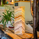 Marble-patterned lamp on a wooden surface with blurred background