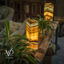 Decorative stone lamps on a wooden table with plants in a cozy indoor setting, featuring the Vilona brand.