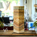 Marble-patterned lamp on a wooden surface with blurred indoor background