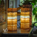 Decorative lamp with layered design on a wooden surface, blurred background