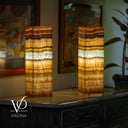 Two layered lampshades on a table with a blurred background