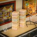 Stacked stone columns on a surface with decorative background