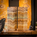 Two onyx stone blocks with a blurred background featuring the brand 'Vilona'.