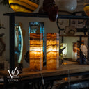 Decorative lamps with a warm glow on a wooden surface, with 'Vilona' branding visible.