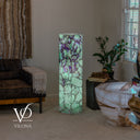 Illuminated Fluorite floor lamp with mint-green stone and deep purple banding concentrated near the top.