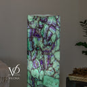47.5-inch Fluorite tower glowing with pale aqua-green crystal sections and violet mineral patterns.