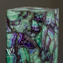Close-up of the illuminated Fluorite corner with pale green crystal textures and deep purple banding.