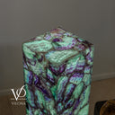Top view of the glowing Fluorite tower showing green and violet patterns across the flat square surface.