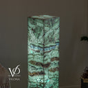 Upper detail of the glowing Fluorite tower showing its flat square top and distinctive blue-violet mineral band.
