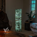 Illuminated Fluorite floor lamp viewed across a furnished room, with green stone and horizontal mineral banding.
