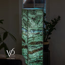 Close-up of an illuminated Fluorite floor lamp with mint-green crystal textures and a blue-violet horizontal band.