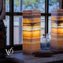 Decorative lamps with layered design in front of a window, featuring the Vilona brand.