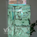 Illuminated Fluorite lamp top showing its flat square surface, mint-green stone, and delicate blue-green bands.