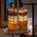 Decorative lamp with layered design on a table, featuring the brand 'Vilona'.