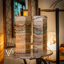 Two marble-patterned lamps on a table with a blurred indoor background