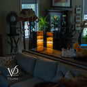 Living room with a coffee table featuring decorative items and a lamp, with 'Vilona' logo in the corner.