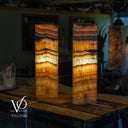 Two layered lampshades on a wooden surface with blurred background