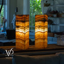Two onyx stone lamps with a blurred indoor background, featuring the Vilona brand.