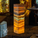Decorative lamp with multicolored stone pattern on a dark background