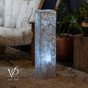 Decorative lamp with a textured surface in a living room setting, featuring the brand 'Vilona'.