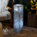 Decorative lamp with agate-like pattern on a table in a cozy room setting.