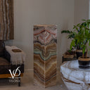 Unlit square Aqua Onyx tower with dark mineral outlines framing pale aqua, rose, and warm beige bands.